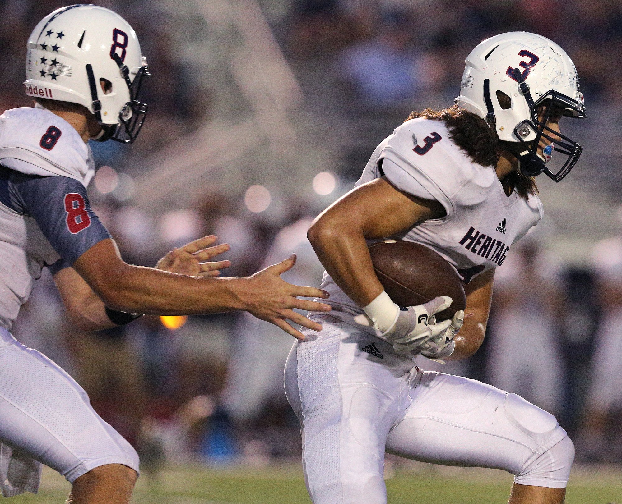 Heritage quarterback Nick Hanson (8) hands the ball off to Maddox Rose (3) during the Ridgeland vs. Heritage football game Friday, September 21, 2018 at Ridgeland High School in Rossville, Georgia.