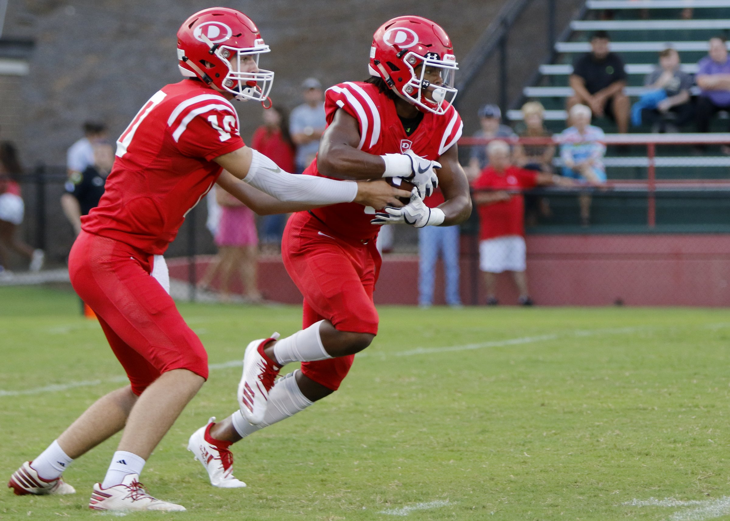 Dalton's Landon Allen (10) hands the ball off to Jahmyr Gibbs (1) during a GHSA football game at Harmon Field against Ringgold on Friday, Aug. 17, 2018 in Dalton, Ga.