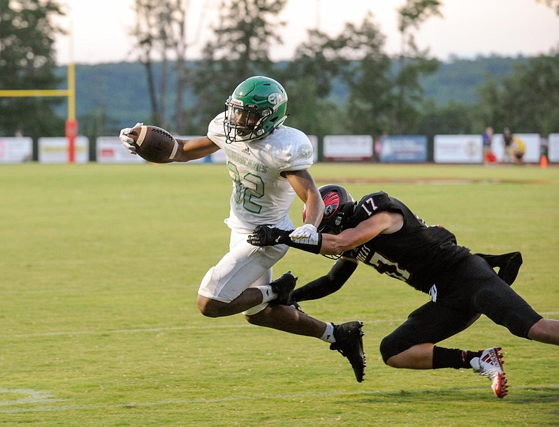 (Photo by Mark Gilliland) East Hamilton's Adam Caudle breaks the tackle of Signal Mountain's Collin Farr for a touchdown during the game against East Hamilton on August 18, 2017.