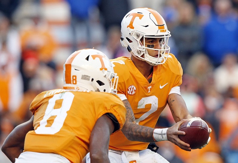 In this Nov. 10, 2018, file photo, Tennessee quarterback Jarrett Guarantano (2) hands the ball off to running back Ty Chandler (8) in an NCAA college football game against Kentucky in Knoxville, Tenn. Tennessee is hoping to improve after going 5-7 in 2018 while posting a second straight last-place finish in the Southeastern Conference Eastern Division. (AP Photo/Wade Payne, File)