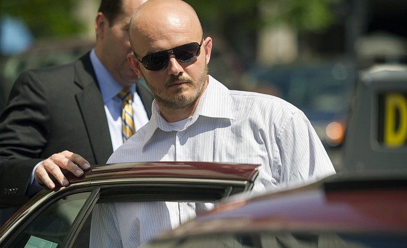 In this June 11, 2014, file photo, former Blackwater Worldwide guard Nicholas Slatten enters a taxi cab as he leaves federal court in Washington, after the start of his trial. A federal judge has sentenced a former Blackwater security contractor to life in prison for his role in the 2007 shooting of unarmed civilians in Iraq. (AP Photo/Cliff Owen, File)