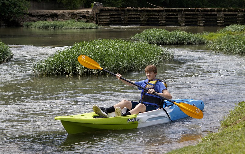 Cody McCutcheon paddles along the West Chickamauga Creek at Lee & Gordon's Mill on June 20, 2018, in Chickamauga, Ga. Walker County announced their "Walker Rocks" marketing initiative at the mill. The initiative is designed to promote the outdoor actives available in Walker County.