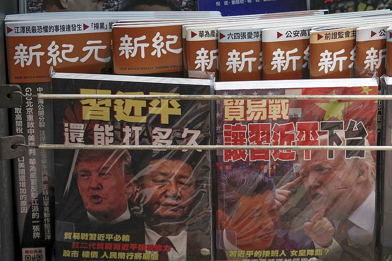 In this July 4, 2019, photo, Chinese magazines with front covers featuring Chinese President Xi Jinping and U.S. President Donald Trump and the trade war are placed for sale at a roadside bookstand in Hong Kong. China on Thursday threatened retaliation if Washington steps up the war over trade and technology by going ahead with planned Sept. 1 tariff hikes on additional Chinese imports. (AP Photo/Andy Wong, File)