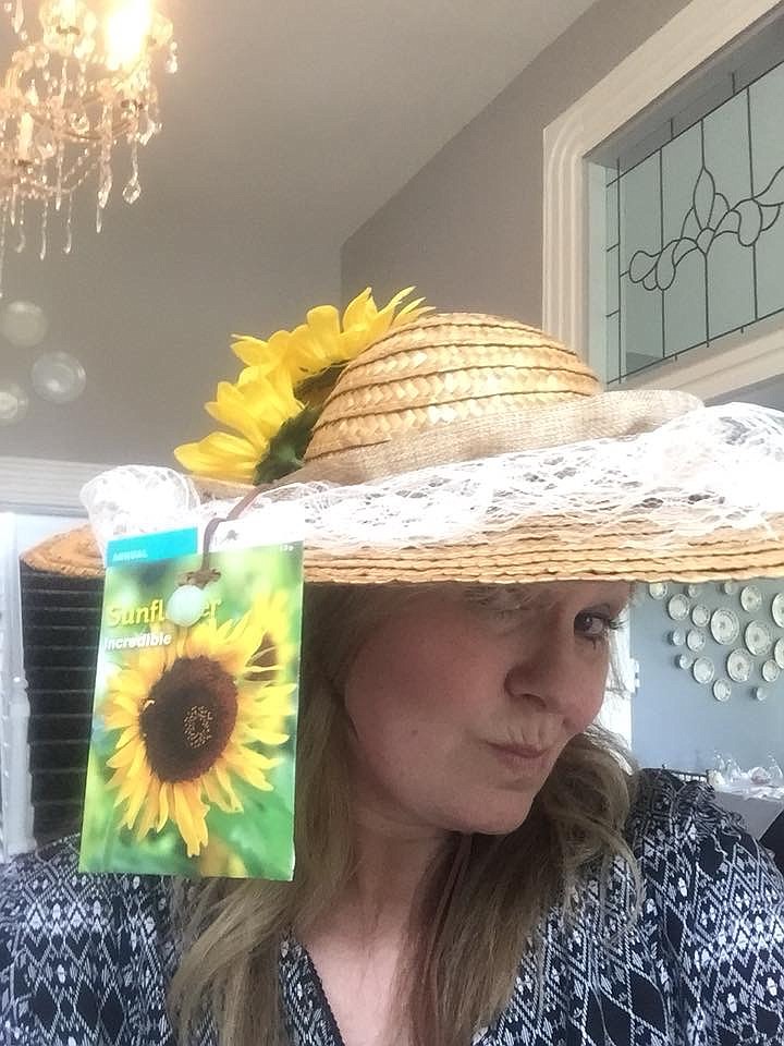 Sunflowers, burlap and lace embellish a straw gardening hat from last year's Hats Off to a Good Cause, a fundraiser for Bethel Bible Village. Polly Claire's tearoom owner Rashelle Stafford models the entry.