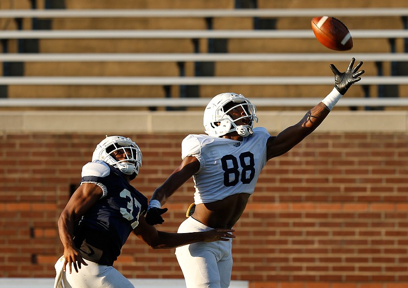 Staff photo by Doug Strickland/ UTC wide receiver Juwan Tyus stretches for a pass ahead of defensive back Jelen Lee during a University of Tennessee at Chattanooga football scrimmage at Finley Stadium on Thursday, Aug. 15, 2019, in Chattanooga, Tenn. 