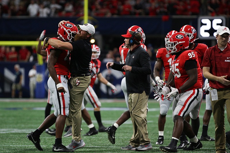 Georgia players celebrate around coach Kirby Smart during last December's SEC championship game against Alabama, a contest the Bulldogs led by two touchdowns before losing.