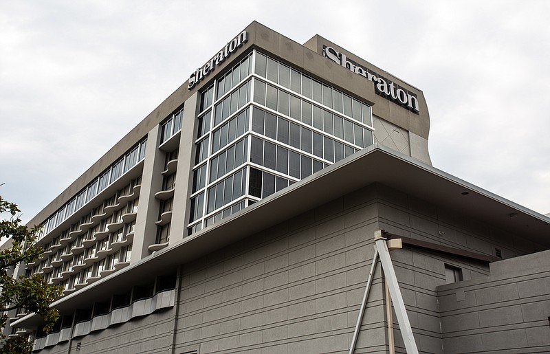 In this Wednesday, July 31, 2019 file photo, the entrance to the Sheraton Atlanta Hotel is seen, in Atlanta. A lawsuit alleges "negligence in the operation and maintenance of the water systems" caused a Legionnaires' disease outbreak at a downtown Atlanta hotel. The lawsuit was filed Monday in Gwinnett County State Court by Germany Greer, who says he tested positive for the disease after attending a conference at the Sheraton Atlanta Hotel June 27-July 1. (AP Photo/Ron Harris, File)