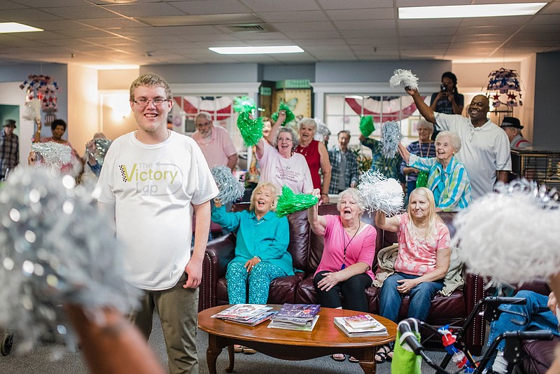 Residents of East Ridge Residence welcome new neighbor John Payne, who recently moved into the senior living community as the first local participant in the Victory Lap program for former foster home residents. / Contributed photo by Kristin Moore