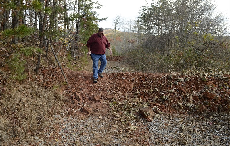In this file photo from Nov. 6, 2014, Jim Sirmans, member of the Coker Creek Heritage Group, scales one of at least 32 earthen berms that were mistakenly built by the U.S. Forest Service in March 2014 on a segment of the Trail of Tears. The photo at right, taken Aug. 14, 2019, shows how kudzu has grown over the same berm at the trail segment's entrance.