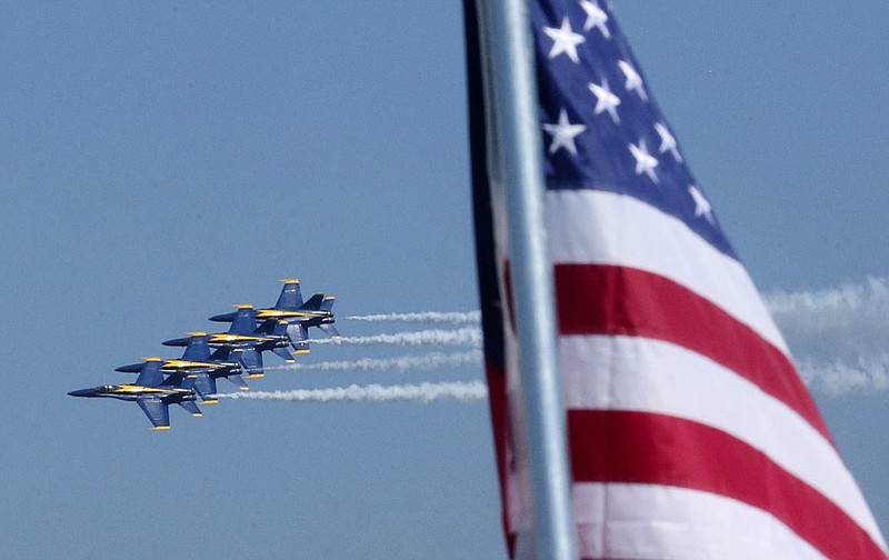 The Blue Angels are seen flying by an American Flag during Seafair on Sunday, Aug. 4, 2019 as viewed from the Stan Sayres Pits on Lake Washington in Seattle. 211063  The Blue Angels fly by an American flag during Seafair on Sunday, viewed from the Stan Sayres Pits on Lake Washington in Seattle, Sunday, Aug. 4, 2019. (KEN LAMBERTTHE SEATTLE TIMES VIA AP)