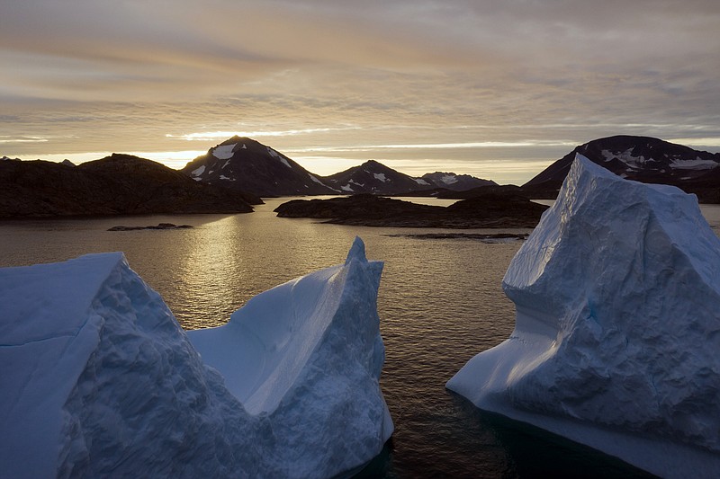 An aerial view of large Icebergs floating as the sun rises near Kulusuk, Greenland, early Friday, Aug. 16, 2019. Greenland has been melting faster in the last decade and this summer, it has seen two of the biggest melts on record since 2012. (AP Photo/Felipe Dana)