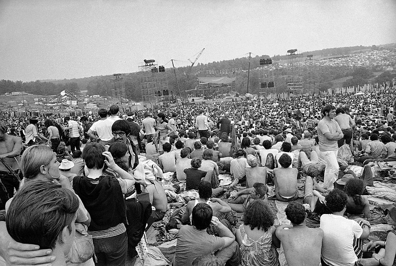 This Aug. 14, 1969 file photo shows a portion of the 400,000 concert goers who attended the Woodstock Music and Arts Festival held on a 600-acre pasture near Bethel, N.Y. Fifty years at Woodstock, the mystical and messy event that became the father of all musical festivals, the entertainment industry is diluted with festivals and events like it, some genre specific, some extremely diverse and others offering experiences in addition to music, ranging from food to art, in order to appeal to wider audiences. (AP Photo/File)