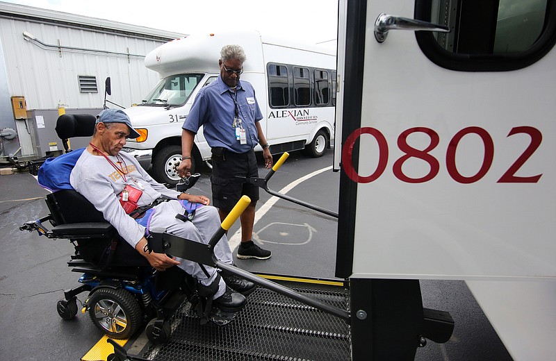 Jeffery Henson is lifted onto the bus by Dewayne Benton, a driver at Alexian Brothers PACE, as he goes home for the day Tuesday, July 23, 2019 in Chattanooga, Tennessee. Before getting assistance from PACE, Henson would call 911 up to 85 times in a month to get help with all aspects of his life, but now, the assistance he receives from PACE takes care of most of his needs.