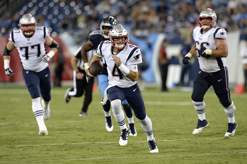 New England Patriots quarterback Jarrett Stidham (4) scrambles against the Tennessee Titans in the second half of a preseason NFL football game Saturday, Aug. 17, 2019, in Nashville, Tenn. (AP Photo/Mark Zaleski)