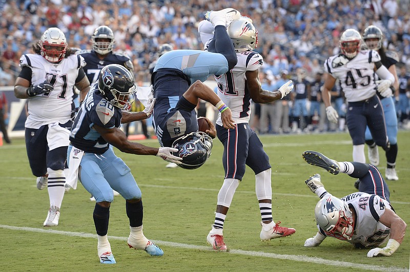 Tennessee Titans quarterback Marcus Mariota flips into the end zone on a 2-point conversion against the New England Patriots in the first half of their preseason game Saturday night in Nashville.