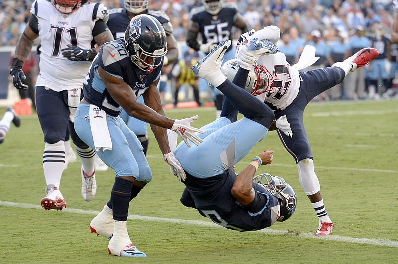 Tennessee Titans quarterback Marcus Mariota (8) flips into the end zone as he converts a 2-point conversion against the New England Patriots in the first half of a preseason NFL football game Saturday, Aug. 17, 2019, in Nashville, Tenn. (AP Photo/Mark Zaleski)