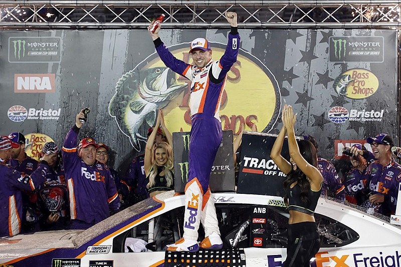 Denny Hamlin celebrates in victory lane Saturday night at Bristol Motor Speedway after earning his fourth NASCAR Cup Series win of the year.