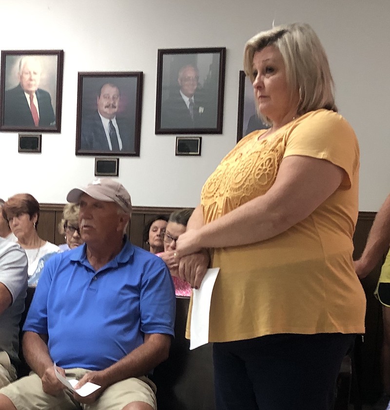 Ed Freeman, left, and Linda Mason, standing, discuss retirement issues with the Jasper Board of Mayor and Aldermen at its August meeting.