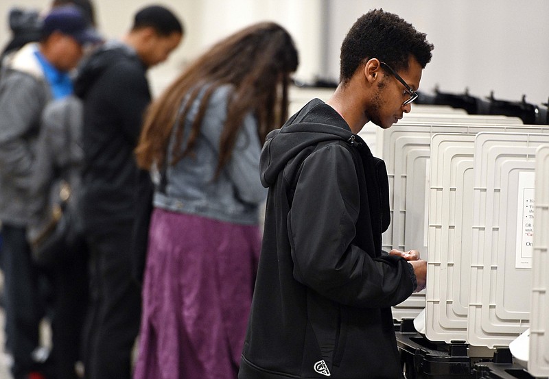 In this Oct. 27, 2018, file photo, people cast their ballots ahead of the Nov. 6, general election at Jim Miller Park in Marietta, Ga. Georgia election officials have little room for error as they work to replace thousands of outdated voting machines statewide in only a matter of months. The state is making a $106 million purchase of new voting machines. (AP Photo/Mike Stewart, File)