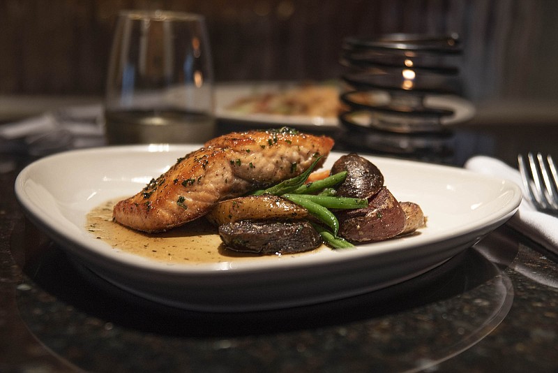 Honey-glazed Faroe Islands salmon served with confit fingerling potatoes, green beans and caramelized carrots.