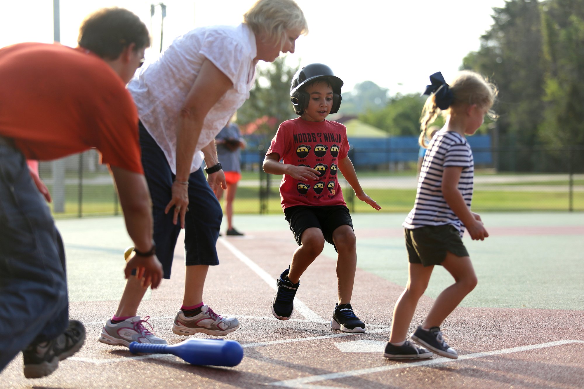 Staff photo by Erin O. Smith / Darlene Lentz, a vocational consultant with Siskin Hospital and board member with Cattanooga Area Brain Injury Association, tells Charlotte Jewell, 3, to run to first as Joseph Swabb, 7, crosses home plate during the Miracle League survivors vs. miracles ball game August 20, 2019 in Chattanooga, Tennessee. The Chattanooga Area Brain Injury Association will be hosting a fundraiser luncheon September 24, 2019 at the Chattanooga Convention Center.
