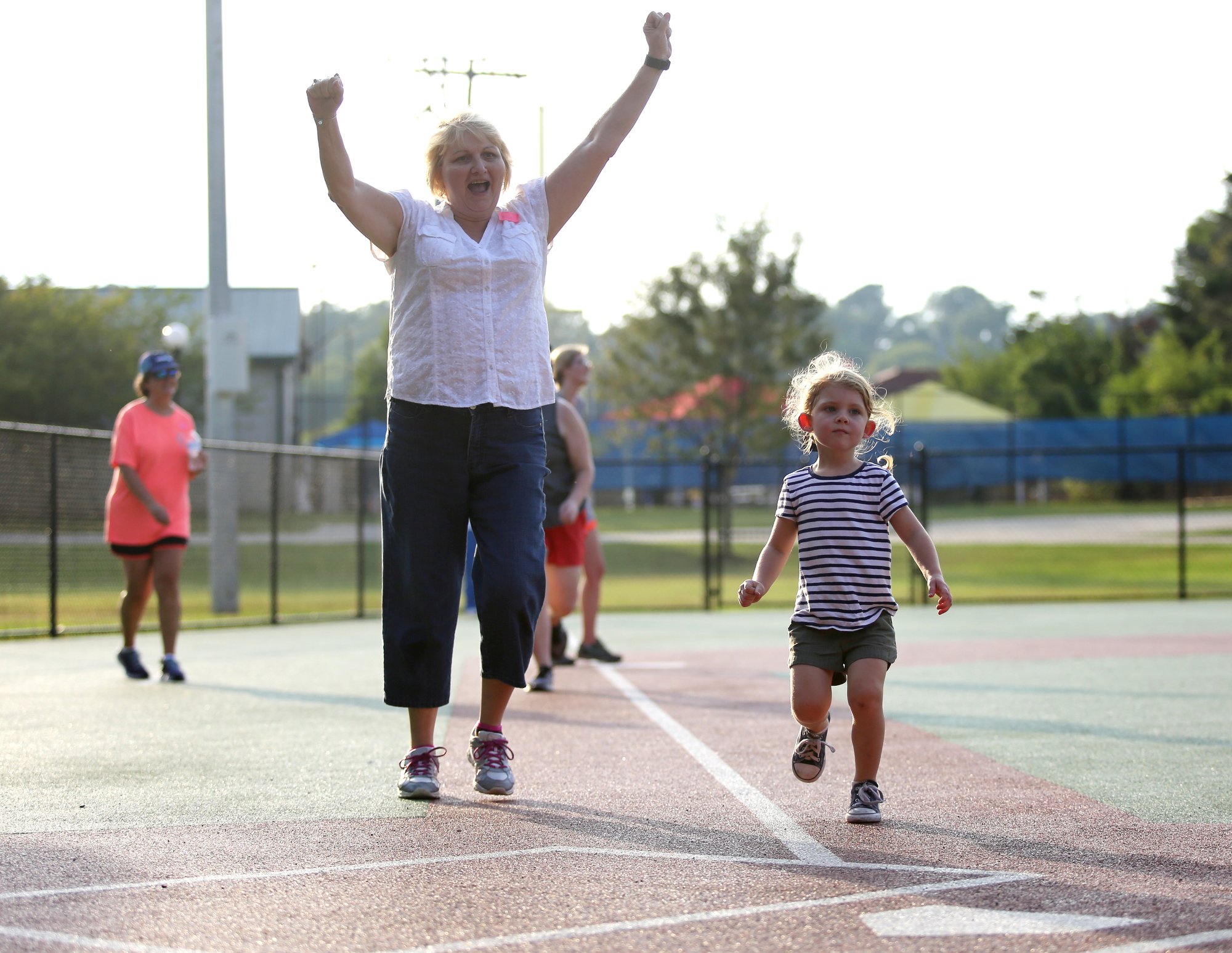 Staff photo by Erin O. Smith / Darlene Lentz, a vocational consultant with Siskin Hospital and board member with Chattanooga Area Brain Injury Association, celebrates as Charlotte Jewell, 3, crosses the plate during the Miracle League survivors vs. miracles ball game August 20, 2019 in Chattanooga, Tennessee. The Chattanooga Area Brain Injury Association board members and support group members participated in the event as well.