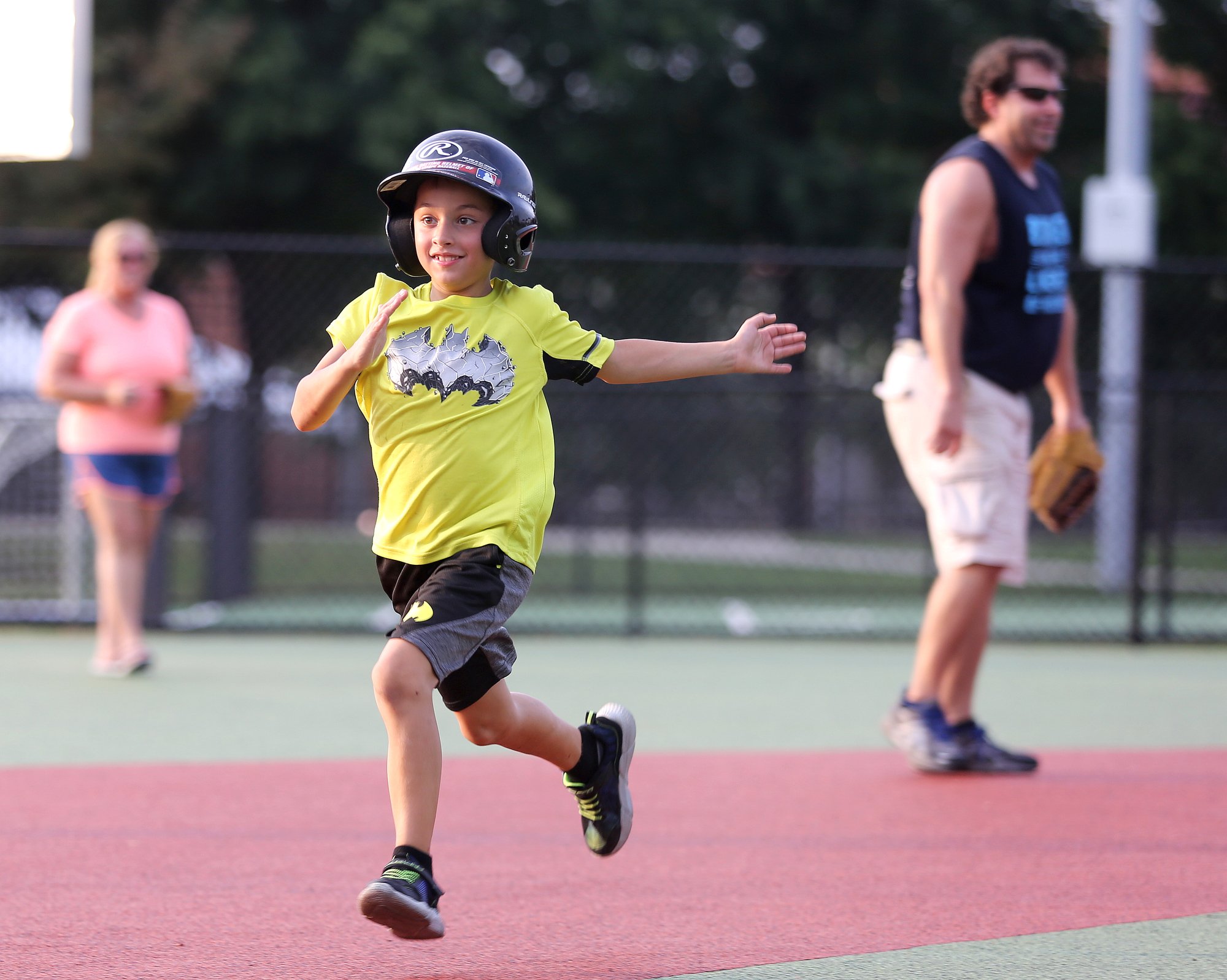 Staff photo by Erin O. Smith / Gabby Swabb, 7, runs to third during the Miracle League survivors vs. miracles ball game August 20, 2019 in Chattanooga, Tennessee. The event was a part of the monthly support group for those with brain injuries and was held to promote education on brain injuries and encourage socialization among those those with brain injuries.