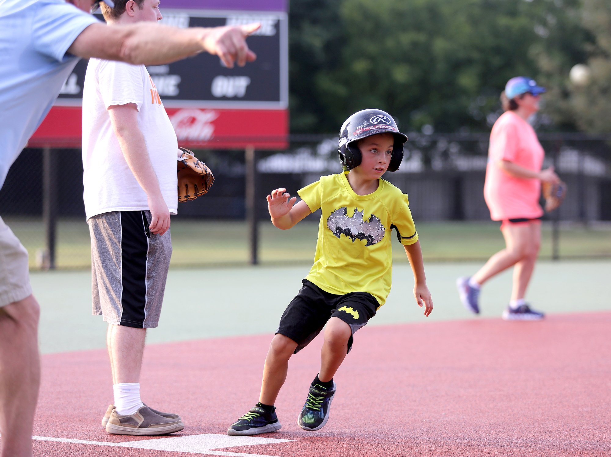 Staff photo by Erin O. Smith / Gabby Swabb, 7, is waved on toward home during the Miracle League survivors vs. miracles ball game August 20, 2019 in Chattanooga, Tennessee. The event was a part of the monthly support group for those with brain injuries and was held to promote education on brain injuries and encourage socialization among those those with brain injuries.
