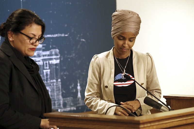 Rep. Ilhan Omar, D-Minn., right, and Rep. Rashida Tlaib, D-Mich., take a quiet moment as they talked about Israel's refusal to allow them to visit the country during a news conference Monday, Aug. 19, 2019, at the State Capitol in St. Paul, Minn. (AP Photo/Jim Mone)