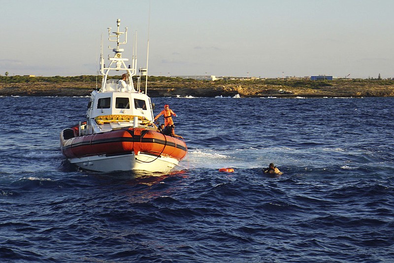 A man who threw himself in the water from the Open Arms vessel, is intercepted by the Italian Coast guards as he tried to swim to the island of Lampedusa, Tuesday.