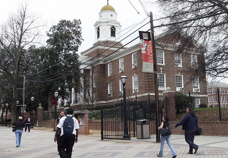 In this Feb. 12, 2009 file photo, people make their way on the Clark Atlanta University campus in Atlanta Ga. Four college students were wounded when a gunman opened fire into a crowd of 200 people outside a library near Clark Atlanta University and then escaped in the chaos, authorities said. All four injured women were in stable condition after the gunfire, which happened shortly after 10:30 p.m. Tuesday, Aug. 20, 2019. None of their injuries were life-threatening, Atlanta police said. (AP Photo/W.A. Harewood, File)