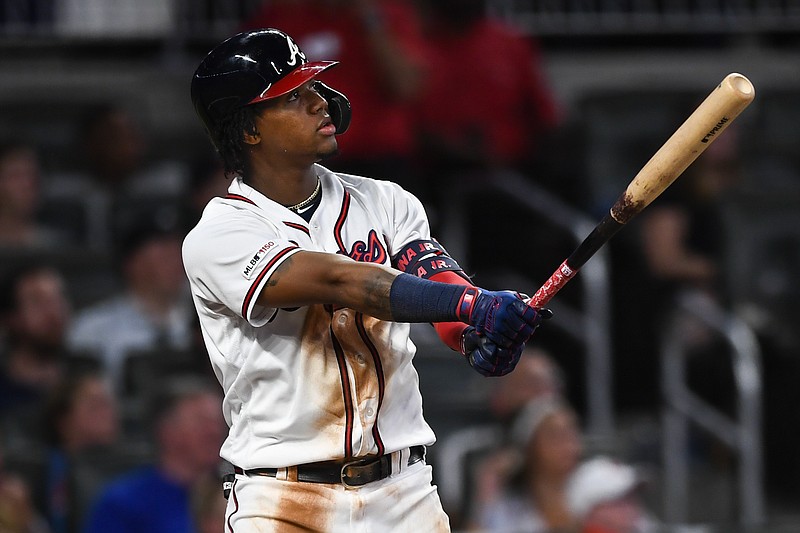 The Atlanta Braves' Ronald Acuna Jr. watches his two-run homer fly over the wall in center field at SunTrust Park during the fifth inning of Wednesday night's game against the Miami Marlins.