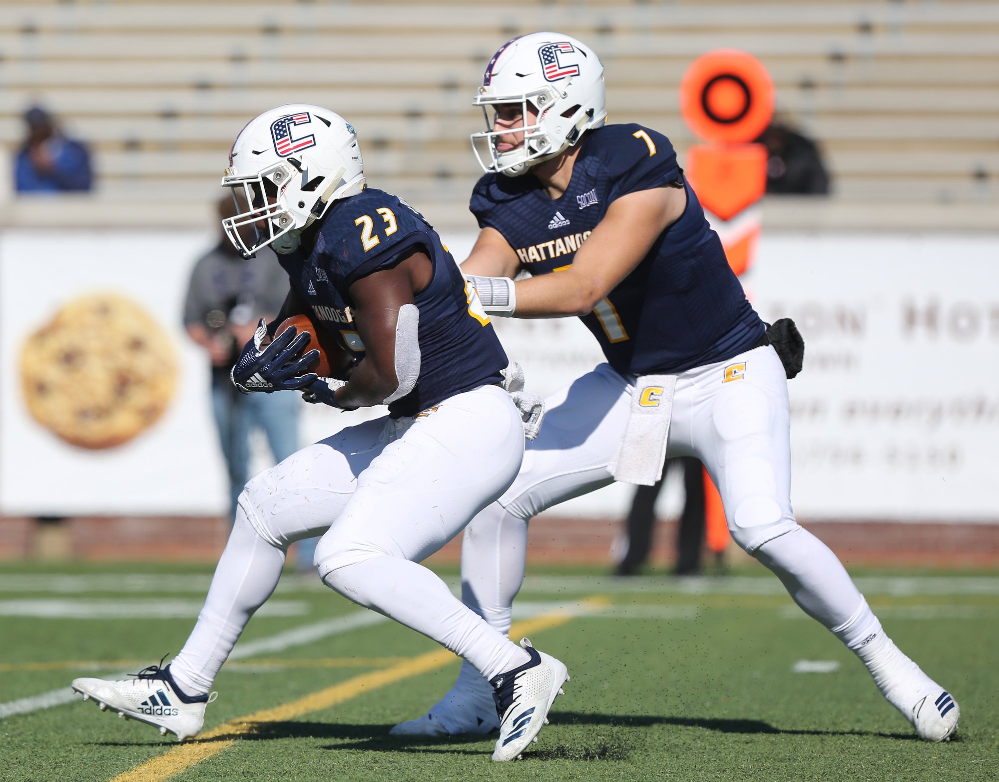 University of Tennessee at Chattanooga running back Tyrell Price (23) takes the handoff from quarterback Nick Tiano (7) during the first half of the Mercer vs. UTC football game Saturday, November 10, 2018 at Finley Stadium in Chattanooga, Tennessee.