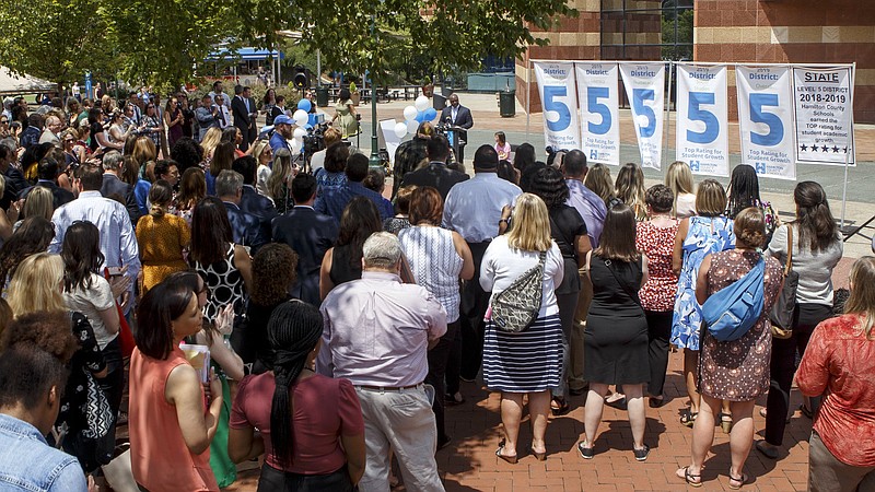 Staff photo by C.B. Schmelter/ Superintendent Bryan Johnson, top center, speaks during a press conference after unveiling the Hamilton County Schools' TNReady test score results and TVAAS scores at the Tennessee Aquarium on Wednesday, Aug. 14, 2019 in Chattanooga, Tenn.