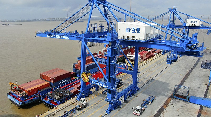 FILE - In this July 18, 2019, file photo, shipping containers are loaded onto a cargo ship at a port in Nantong in eastern China's Jiangsu province. Beijing appealed to Washington on Wednesday, Aug. 21, to "meet China halfway" and end a tariff war after President Donald Trump said Americans might need to endure economic pain to achieve longer-term benefits. (Chinatopix via AP)