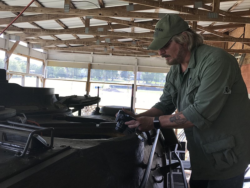 Marietta resident George Adler photographs the work he's done on the 6th Calvary Museum's M47 Patton battle tank. / Staff photo by Sabrina Bodon