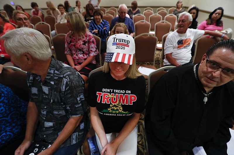 Lisa Mankiewicz sits in the audience during a training session for Women for Trump, An Evening to Empower, in Troy, Mich., Thursday, Aug. 22, 2019. President Donald Trump's campaign is rallying and training a corps of female defenders, mindful that Trump's shaky standing with women could sink his hopes of reelection next year. Female surrogates and supporters fanned out across important battlegrounds Thursday in a high-profile push to make the president's case on the economy and to train campaign volunteers. (AP Photo/Paul Sancya)