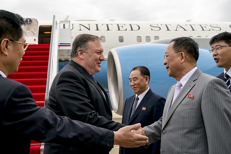 In this July 6, 2018, file photo, U.S. Secretary of State Mike Pompeo, second from left, is greeted by North Korean Director of the United Front Department Kim Yong Chol, center, and North Korean Foreign Minister Ri Yong Ho, second from right, as he arrives at Sunan International Airport in Pyongyang, North Korea. Ri called Pompeo a "poisonous plant of American diplomacy" who hampers efforts to restart nuclear negotiations. Ri issued crude insults against Pompeo on Friday, Aug. 23, 2019, to protest what he called Pompeo's recently reported comments that Washington will maintain crippling sanctions on North Korea unless it denuclearizes. (AP Photo/Andrew Harnik, Pool, File)