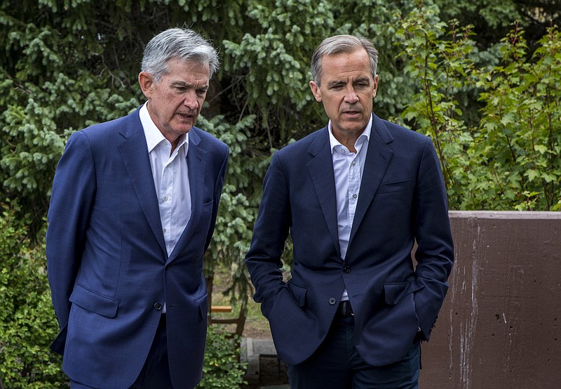 Federal Reserve Chairman Jerome Powell, left, and Bank of England Governor Mark Carney, right, walk together after Powell's speech at the Jackson Hole Economic Policy Symposium on Friday, Aug. 23, 2019, in Jackson Hole, Wyo. (AP Photo/Amber Baesler)