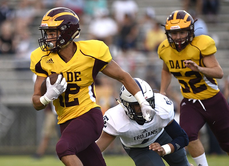 Staff Photo by Robin Rudd/  Dade County's Malaki Webb (12) escapes a Trojan defender on a long gain.  The Gordon Lee Trojans visited the Date County Wolverines in GHSA football action on August 23, 2019.  