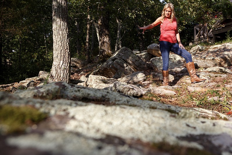 Staff photo by C.B. Schmelter/ Amy Morrow points towards the area where she believed she got bitten by a snake while standing for a photo at her home on Monday, Aug. 19, 2019 in Menlo, Ga.