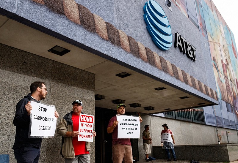 Staff photo by Doug Strickland/ Taylor Brown with the Tri-state Musicians Union, Chris Panter, and Bodine Willis, from left, picket outside of the AT&T Building on Martin Luther King Boulevard on Monday, Aug. 26, 2019, in Chattanooga, Tenn. Local workers joined thousands of AT&T employees on strike across the Southeast as the Communications Workers of America, which represents workers at the company, accuses AT&T of unfair labor practices.