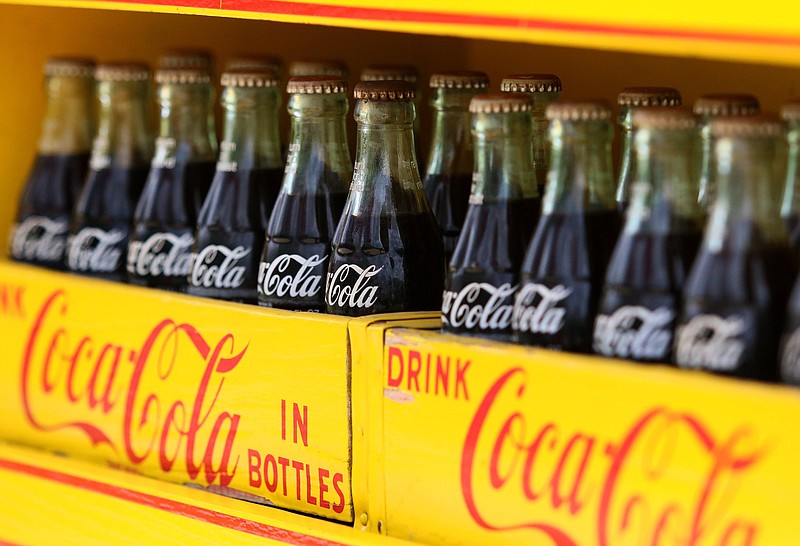 Staff photo by Erin O. Smith / Coca-Cola bottles sit in boxes on an old Ford Model T truck outside Coca-Cola during the 120th anniversary event of Chattanooga Coca-Cola Bottling Co.