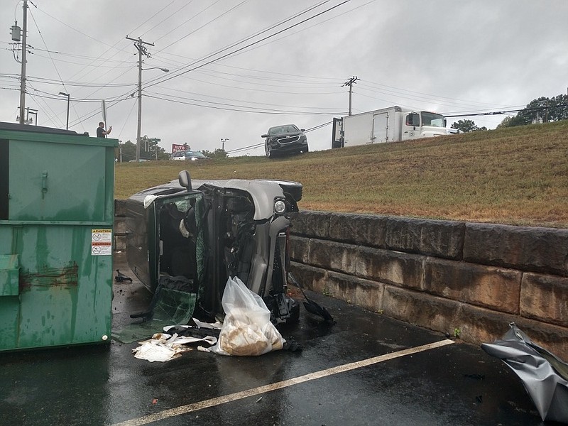 A vehicle sits on its side after going over an embankment at Hixson Pike and Williams Street on the morning of August 26, 2019.
