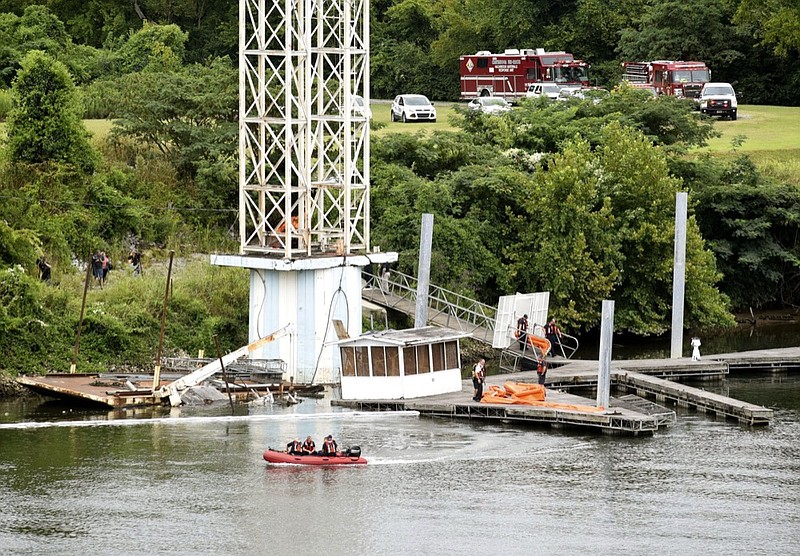 Staff photo by Tim Barber/ A truck and crane is underwater at the former dilapidated Allen Casey barge site on the North Shore between the P.R. Olgiati and the John Ross Bridge.
