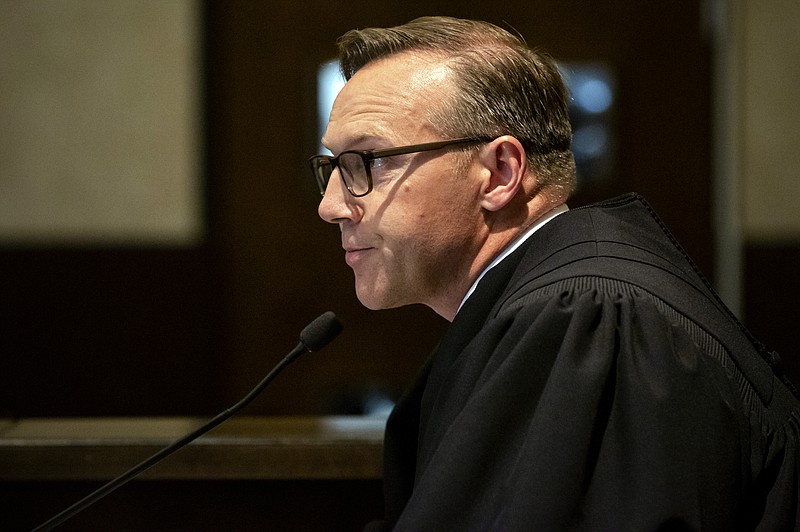 Judge Thad Balkman reads a summary of his decision in the opioid trial at the Cleveland County Courthouse in Norman, Okla., Monday, Aug. 26, 2019. Balkman ruled in favor of the state of Oklahoma and ordered Johnson and Johnson to pay $572 million to a plan to abate the opioid crisis. (Chris Landsberger/The Oklahoman via AP, Pool)