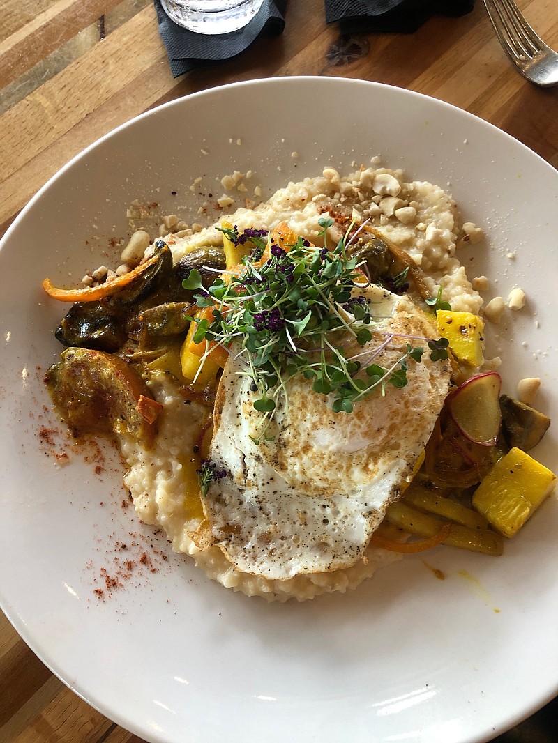 Ben's Breakfast at Flying Squirrel is a plate of roasted farm vegetables, sorghum grits, Thai curry, peanuts and an over-easy egg. / Photo by Kate Brennan