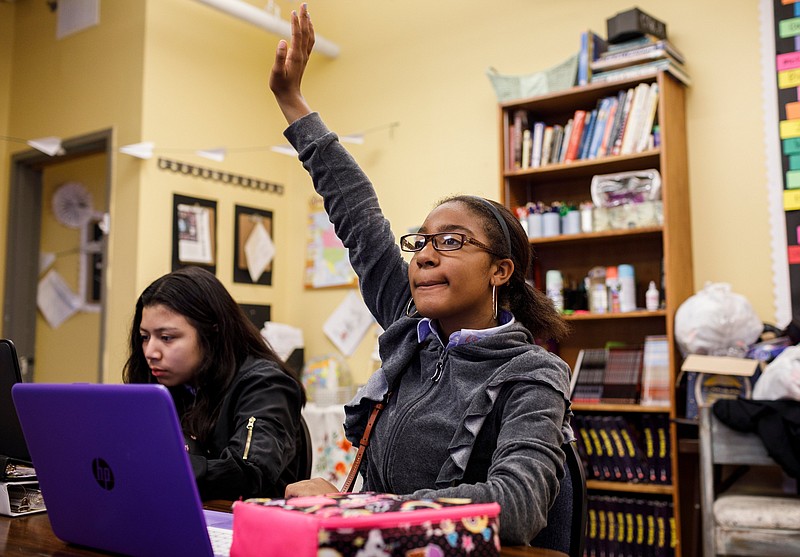 Jada McKamey, right, raises her hand to answer a question during a sixth-grade history class at Chattanooga Girls Leadership Academy in April.