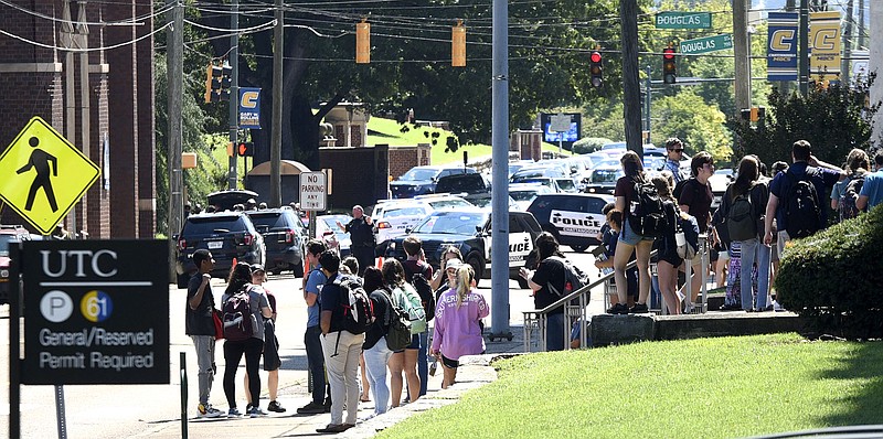 Staff photo by Tim Barber/ Students wait in mass outside the First Presbyterian Church at McCallie and Douglas where police are staging Wednesday at noon.

