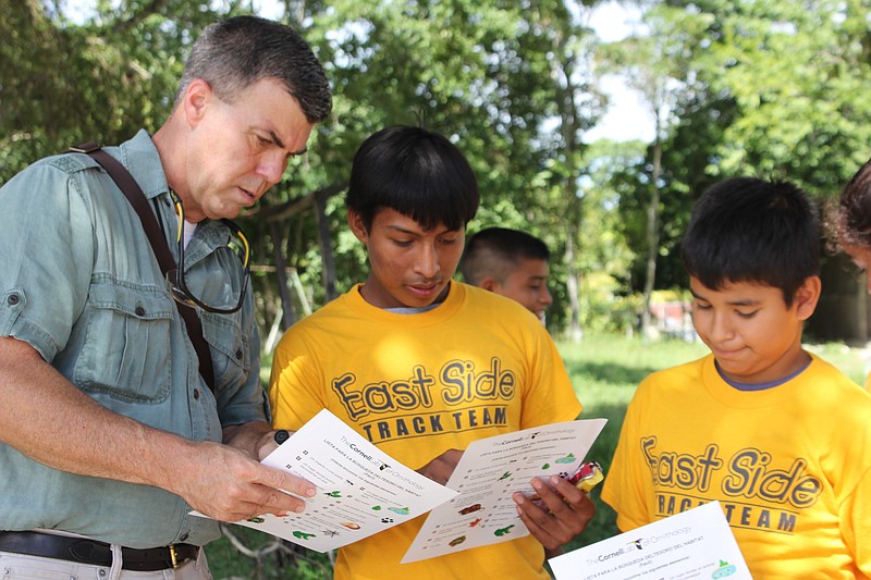 Photo by Eliot Berz / From left, Tennessee River Gorge Trust Executive Director Rick Huffines and a group of Guatemalan students look over a checklist of local wildlife during a jungle walk near the Guatemalan village of Flores.